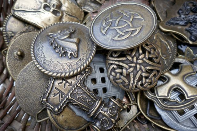 Bronze viking brooches with different symbols.