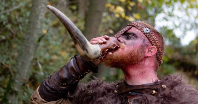 A viking warrior drinking from a horn.