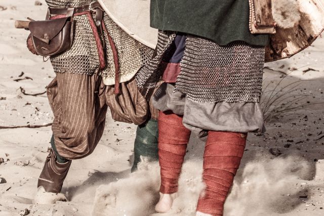 Two viking men in different footwear.