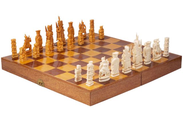 A complete chess set made from carved ivory.