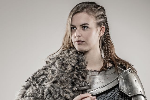 Lagertha braid on a woman in a viking costume.