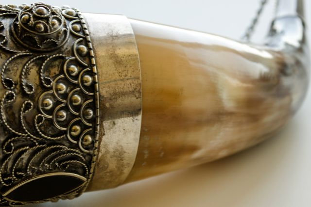 Drinking horn embellished with with intricate metal design.