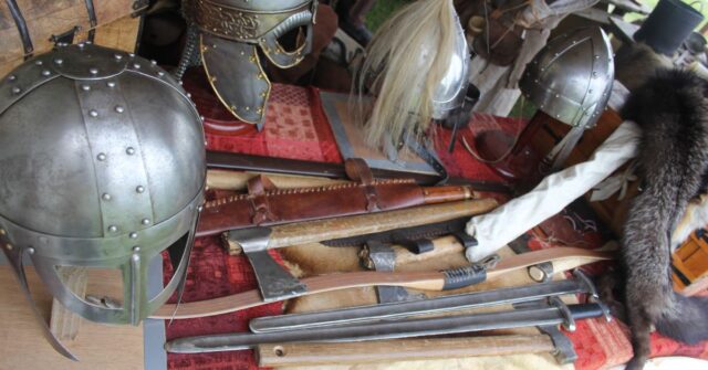 A bunch of viking helmets and weapons replicas.