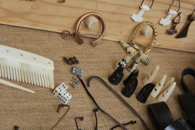 Various viking jewelries on a table.