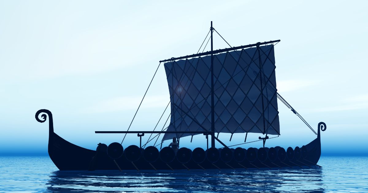 Silohuette of a viking long ship at dawn.