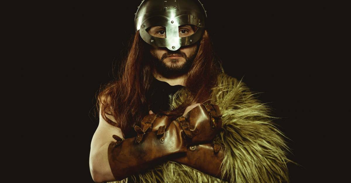 A viking warrior wearing a fur and metal helmet.