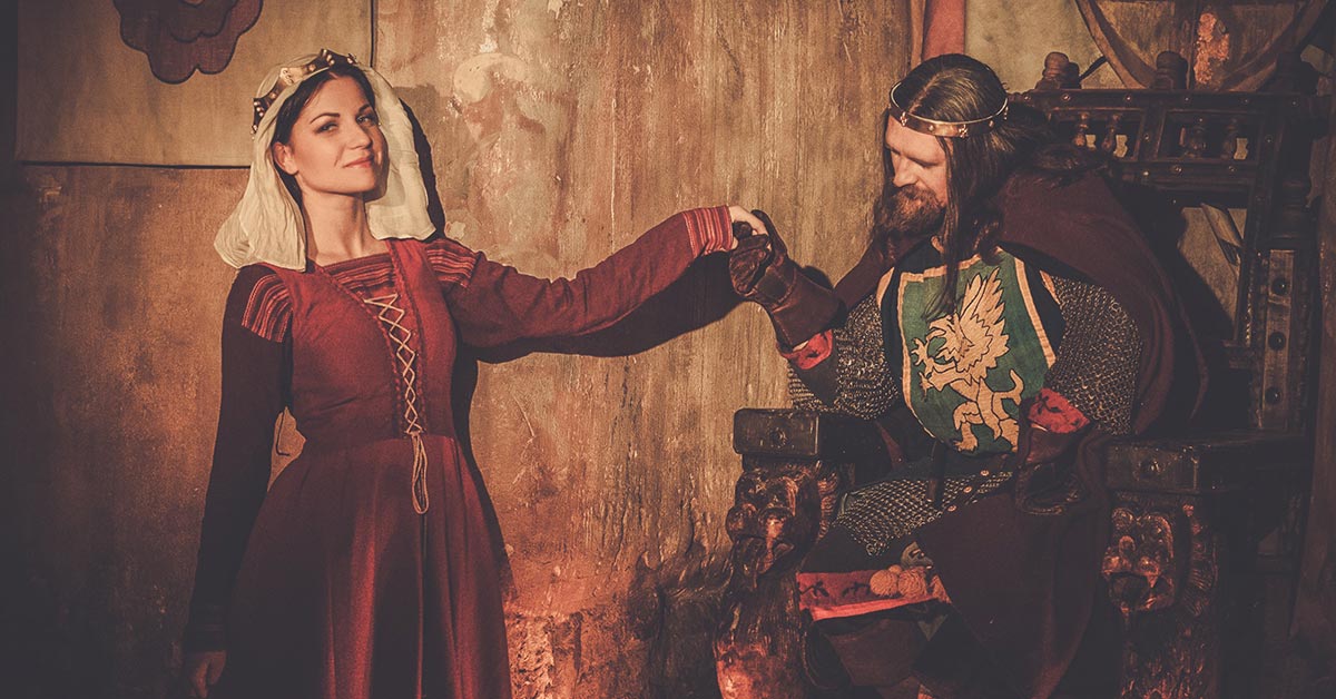 Old style picture of a Medieval king holding his Queen's hand