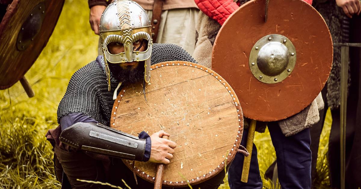 Various medieval vikings holding their weapons and shields.